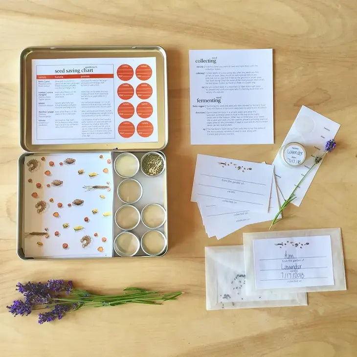 The opened tin with instructions, small seed tins, envelopes, labels, and sprigs of lavender.